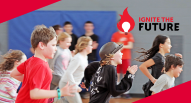 A group of children are running and having fun in a gym. The Ignite the Future logo is on the right side.