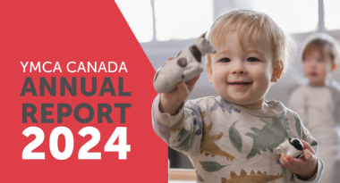 Text: YMCA Canada Annual Report 2024. Image: a little boy is smiling and holding a toy up and showing it.