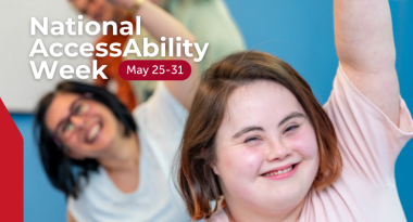 Text: National AccessAbility Week. May 25-31. Image: Three people smiling and raising their arms in a joyful pose during a group activity. 