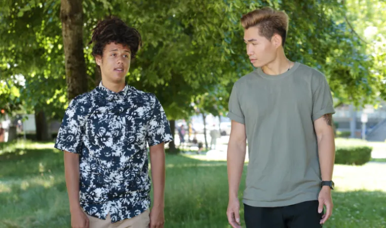 Two people walking outside talking to each other