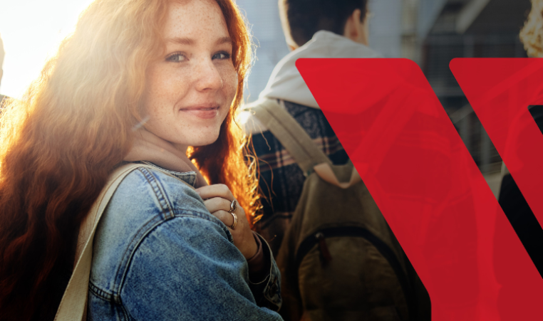 A young woman is looking and smiling. The YMCA is logo is an overlay to the right of her.