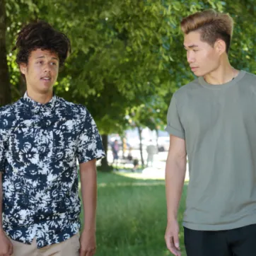 Two people walking outside talking to each other