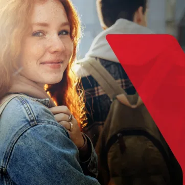 A young woman is looking and smiling. The YMCA is logo is an overlay to the right of her.
